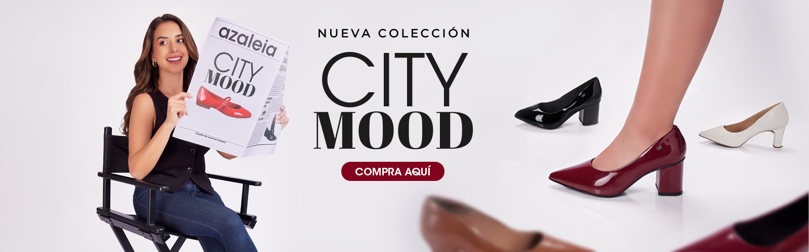 Mujer sonriente sostiene periódico con anuncio de zapatos Azaleia de la nueva colección City Mood, acompañada de varios modelos de tacones en colores vino, negro y blanco.